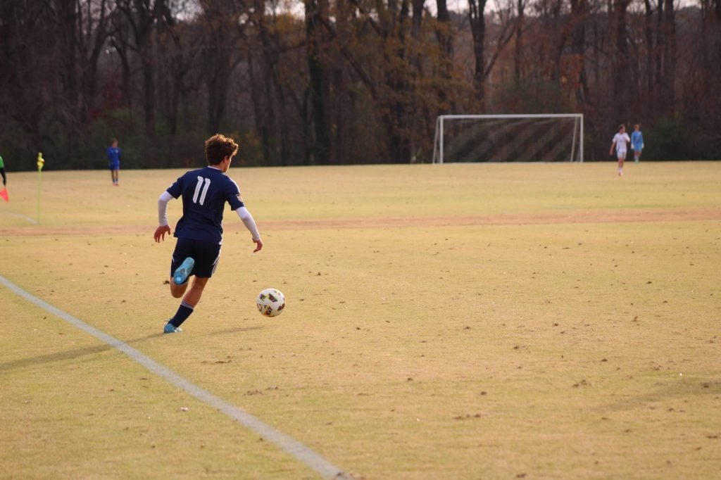Oliver Sovenyhazy dribbling at pace with the ball